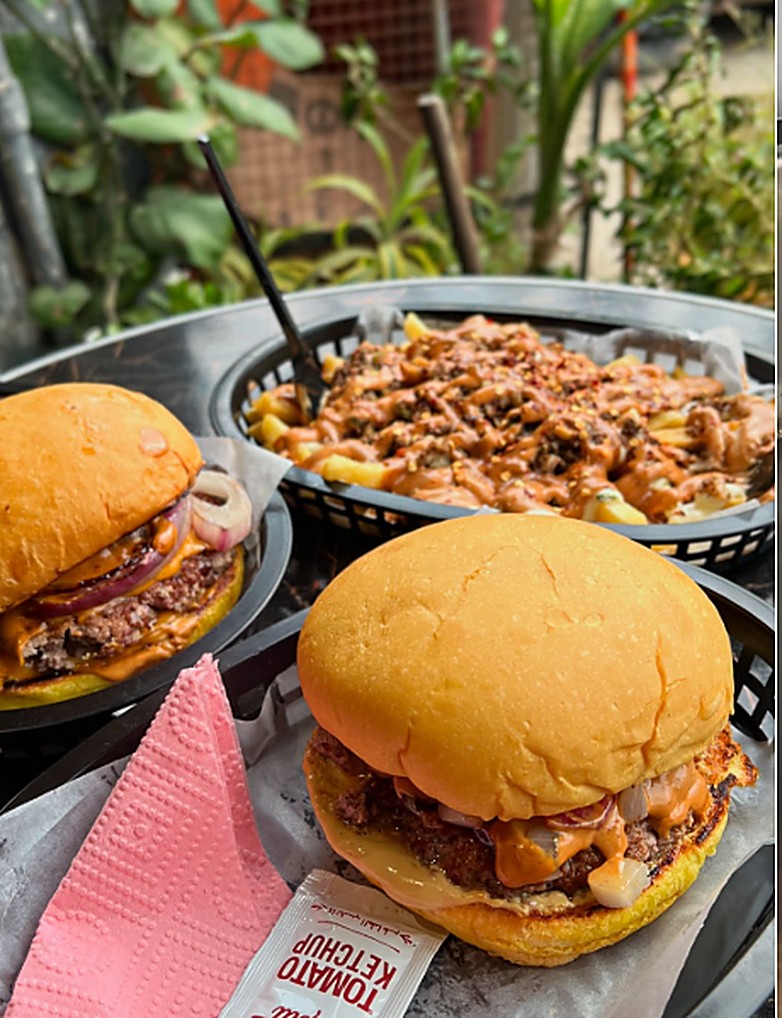 Lorenzo burgers and loaded fries on an outdoor table